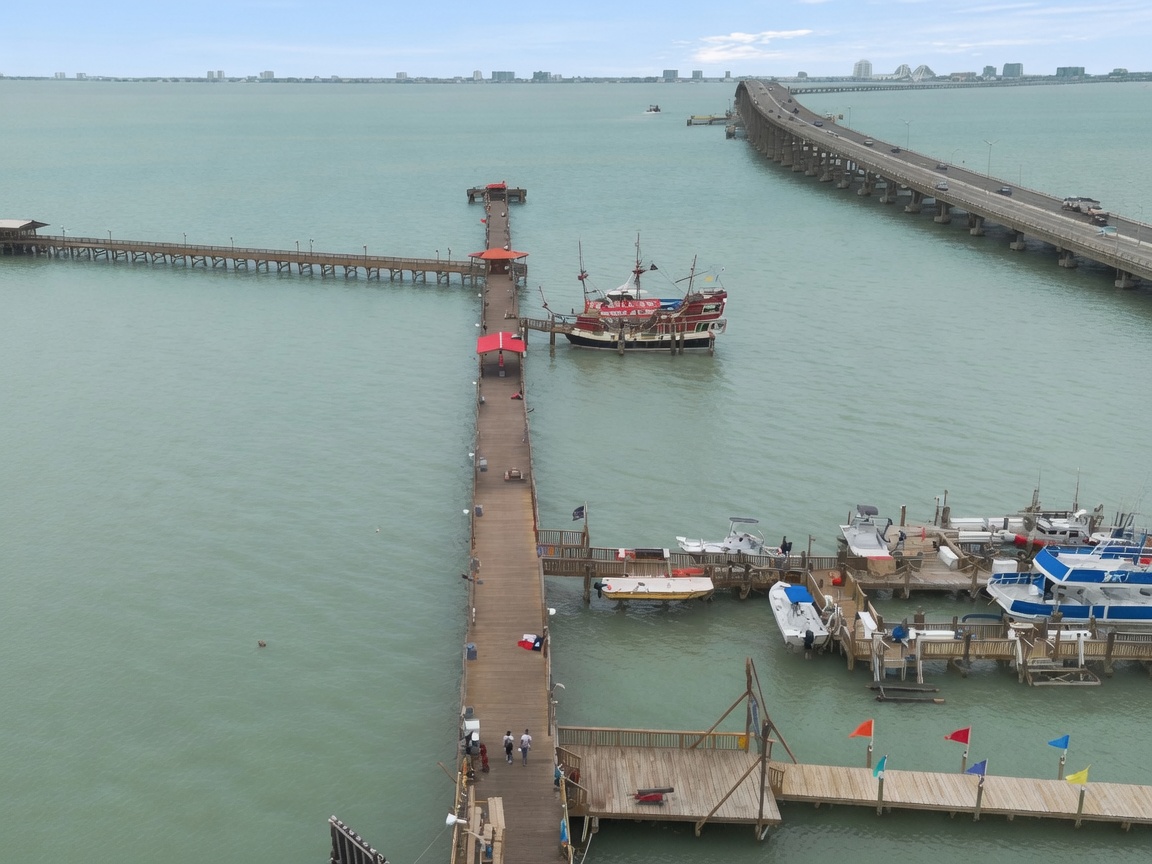 Fishermen and a pirate ship on the long pier at Pirate's Landing, Port Isabel